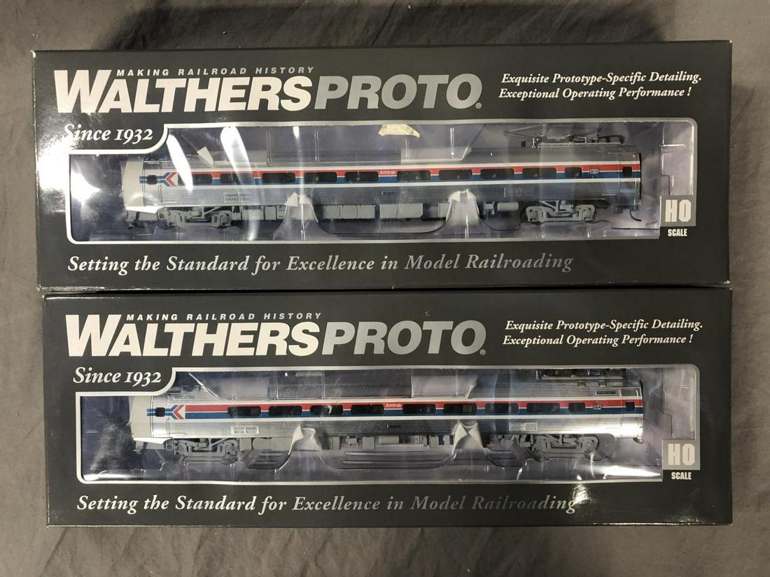 2 Boxed Walthers HO Amtrak Budd Metroliners: Includes 920-14840 Phase I Coach(809); 920-14820 Parlor (884). They are powered and equipped with Tsnumai Sounds and DCC. They appear new in boxes.