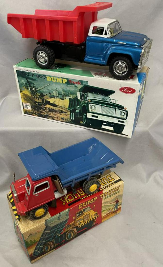 2 Boxed Japanese Tin Dump Trucks: Includes a Asahi Ford Dump Body with plastic rear bed, 11 1/2” long with box inserts; Numora Smaller Quarry dumper with 1 box insert. Both appear like new with boxes.