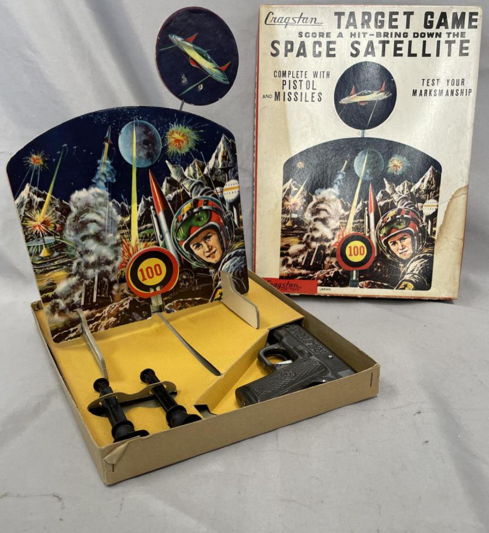 Boxed Cragstan Space Satellite Target Game: Gun is litho tin with 2 plastic darts, functional. Target is paper litho on board, awesome graphics. Strike target and space ship bobs down as if shot. It appears like new with box insert and stained 