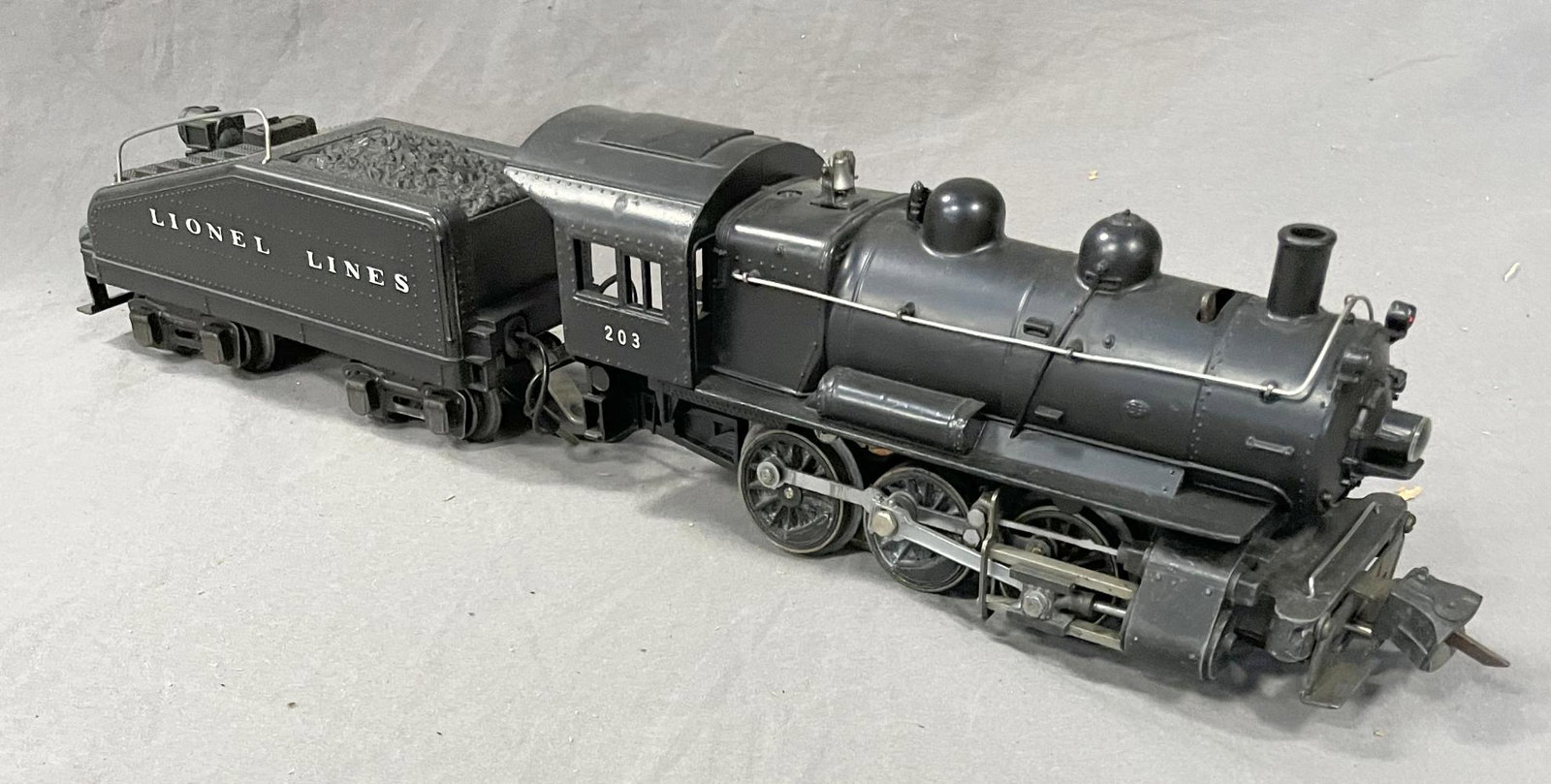 Nice Lionel 203 B6 Switcher: Nice satin Patina with bright lettering and rods. Matching 2203(B) slant back tender with light & bell, though marked â€™T”. It shows light use. Nice example! From The Tony Bifano Estate Co