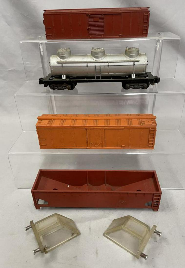 6pc American Flyer Production Samples: S Gauge. Includes a painted hopper; 2 unpainted bumpers with clear plastic molds; 3-d tank, painted and assembled, no decoration; unpainted orange reefer shell; Painted tuscan boxcar shell. Some came 