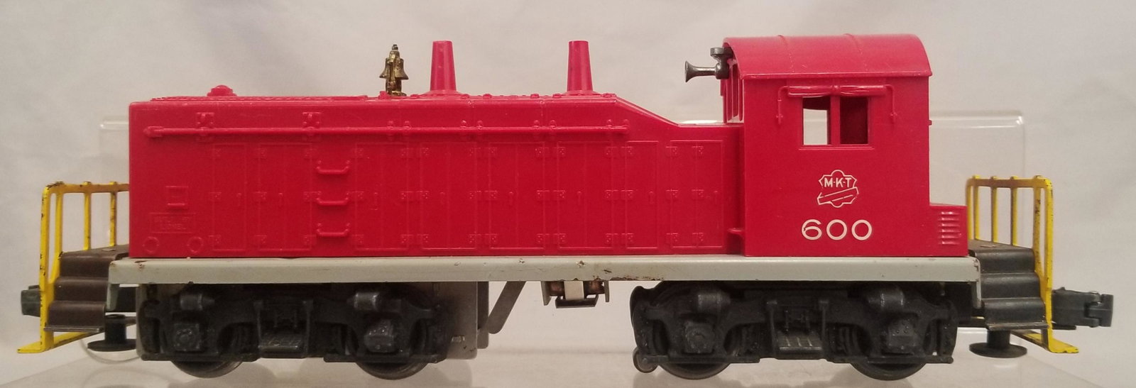 Scarce Lionel 600 MKT NW2 Diesel: Toughest variation with both a gray frame and yellow handrails. cab has a closed hairline screw crack and some paint chips on railings, showing light to moderate playwear From the Estate Collection of