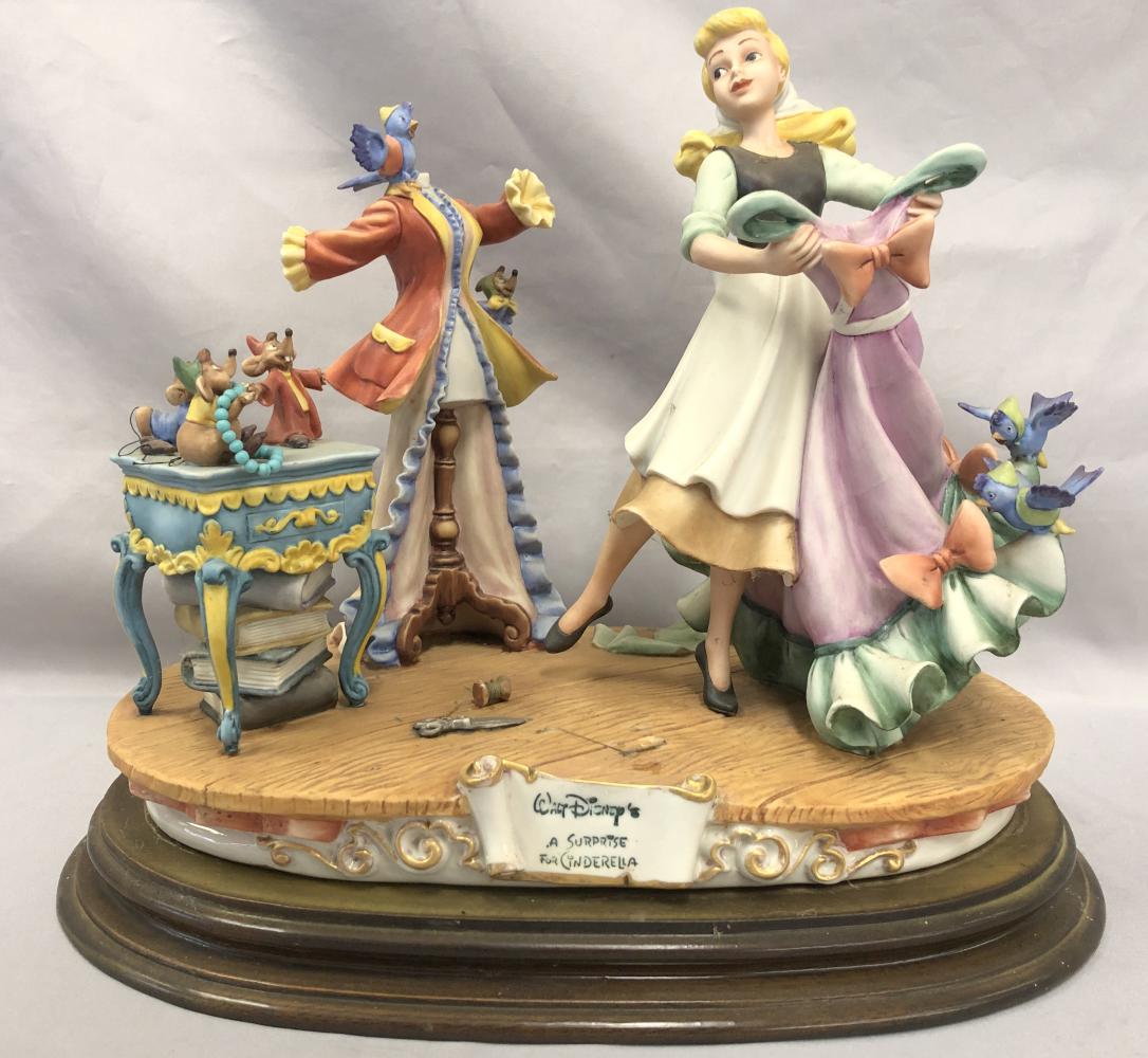 A Surprise for Cinderella, Capodimonte Sculpture: Offered is a Capodimonte porcelain sculpture of Walt Disney's "A Surprise for Cinderella", stamped by artist Enzo Arzenton and produced for the Laurenz Collection, made in Italy. Depicts Cinderella in