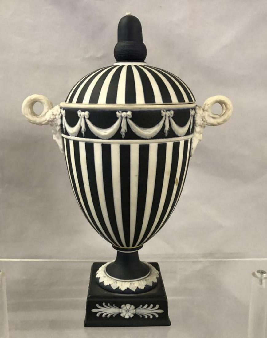 Wedgwood Black Jasper Urn.: Black and White Urn. Bolted. 8 1/2" tall with Satyr Head Handles. Tip of Lid appears cut off a tiny bit, could be repaired.
