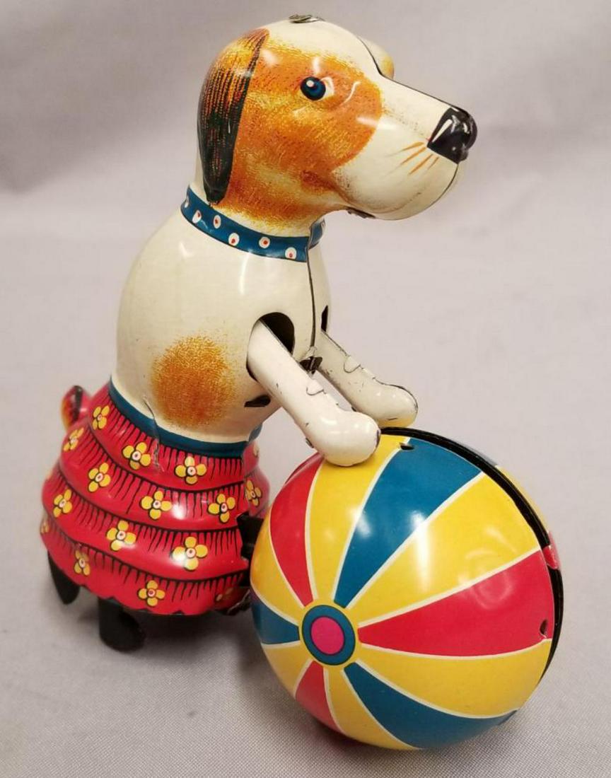 Tin Litho Dog Pushing Ball Wind Up.: Unmarked toy in working order 5" tall by 4" long.