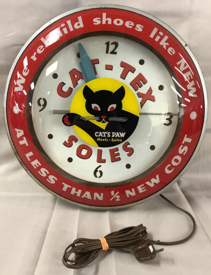 Cats Paw Light-Up Shoe Maker Advertising Clock: Approx. 14" diameter. When tested, the lights worked and all the hands moved continuously at the same time, so the time was not being held. Outer wear with scuffs and scratches, some areas of light ru