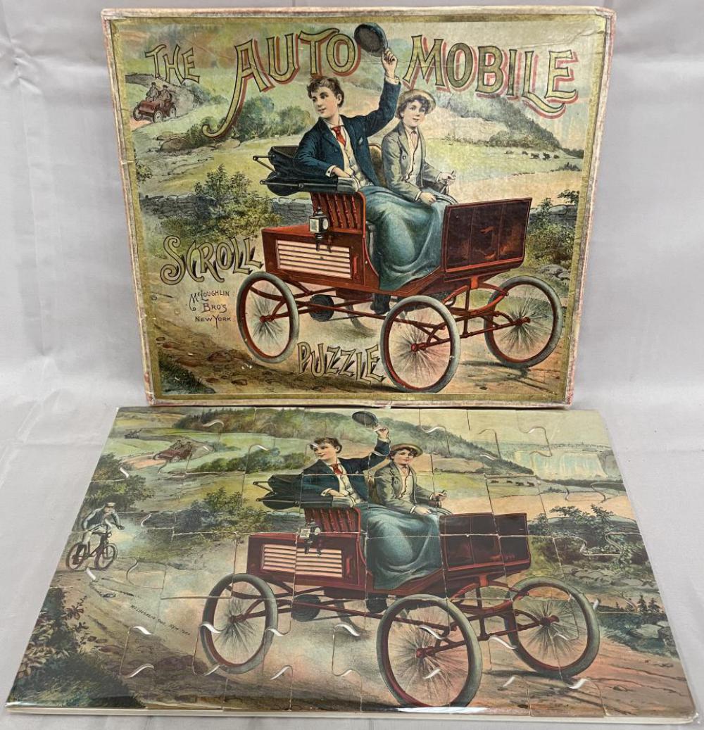 1895 McLoughlin The Auto Mobile Puzzle: Fantastic scroll puzzle of the 1st Tiller car, circa 1895, 10X15”. It is clean and bright with better than average original box.