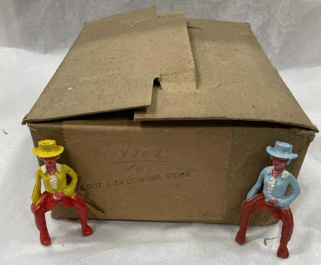 Full Factory Case C-24 Cowgirl Riders: Includes 12 Blue and 12 Yellow examples, all mint in box. They include their original factory rubber-stamped case and worn inserts. From The Jack and Maurice Manoil Family Collection.