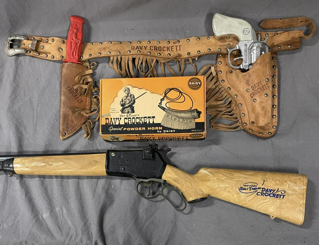 Davy Crocket Western Collectibles: Includes a Stevens Cap Gun & Knife holster set. Gun is functional with nice chrome, rubber knife is intact, but silver shows wear; Boxed Daisy BB plastic Powder Horn in display box; Cap Rifle, functio