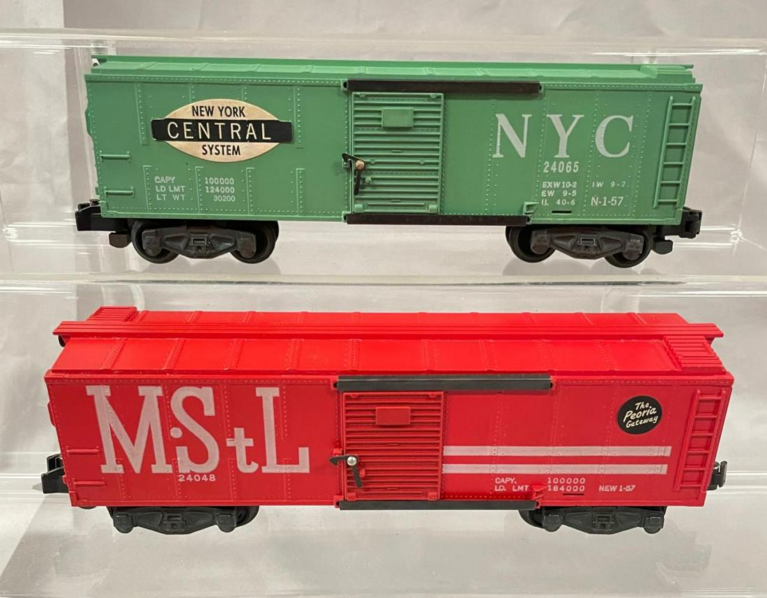 American Flyer S Ga 24065 & 24048 Boxcars: Includes a 24065 NYC with nice stickers, latch nibs and brake-wheel; 24048 M&StL boxcar with nice stickers, lettering, latch nibs and brake-wheel. They are equipped with iron trucks and show very ligh