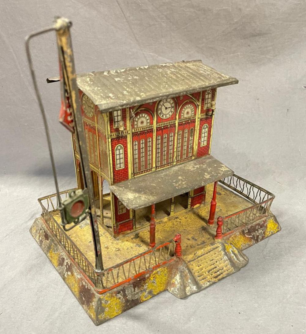 Issmayer Central Sation: Litho & hand-painted tin, 9 1/2 X 7 1/2 X 9 inches. Litho is better than most, paint flaked heavily on roofs. Retains its semaphore, though incomplete, 1 railing is loose.