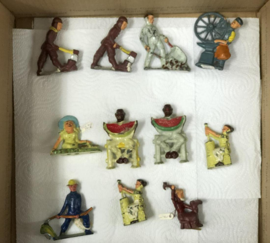 Lot of 11, Manoil Happy Farm Figures: Lot of 11 pieces. Includes 41/20 man dumping wheelbarrow, (2) 41/33 woman with butter churn, 41/21 old man fixing shoe, 41/8 farmer cutting with scythe, (2) 41/18 man chopping wood, 41/22 blacksmith w
