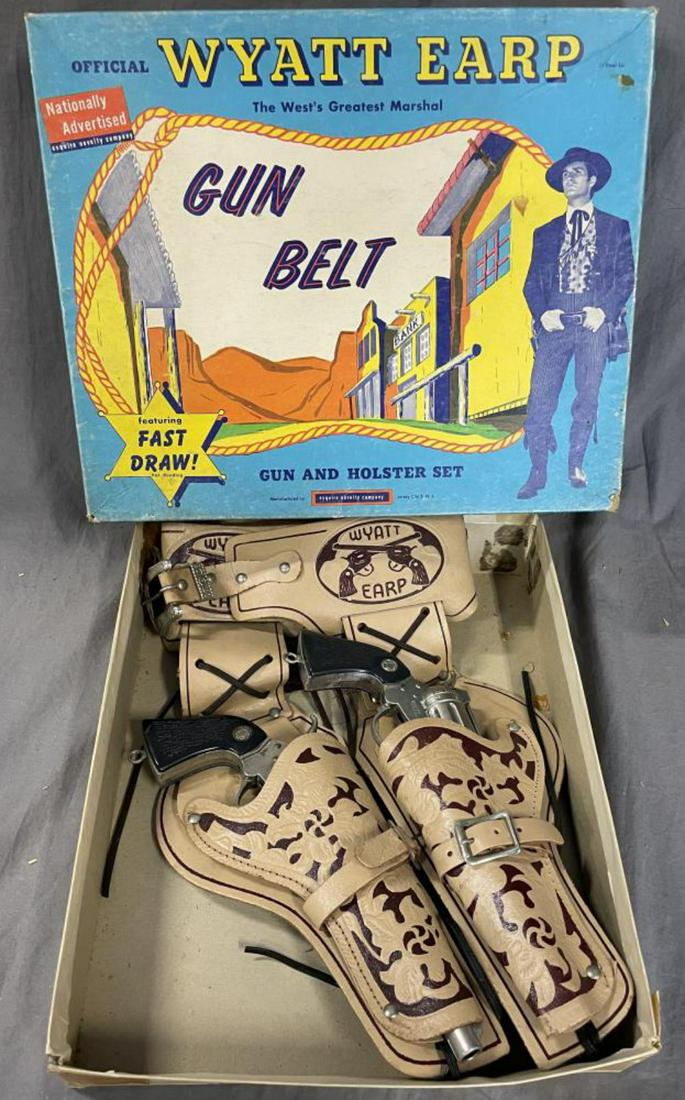 Boxed 1950s Wyatt Erp Cap Gun & Holster Set: by Esquire. #2629. Includes a nice blonde leather double-holster set with all 12 bullets in sleeve. Includes 2 Buntline Special Wyatt Erp Die cast cap guns, both functional and shows light to moderate
