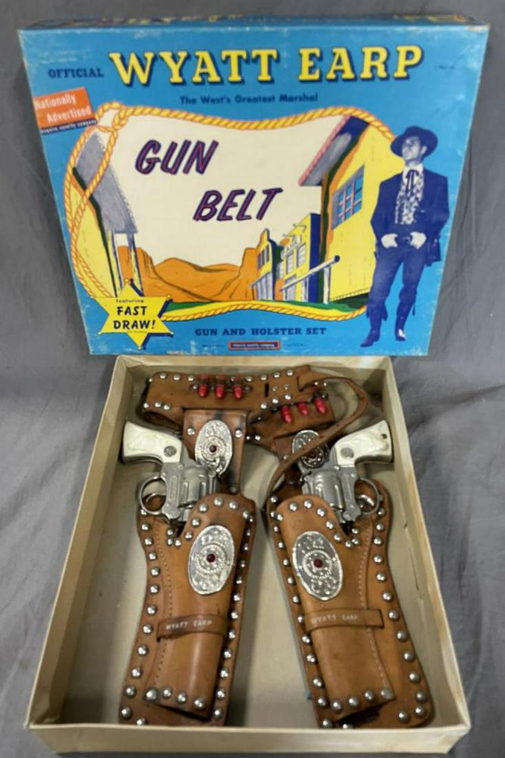 Boxed 1950s Wyatt Earp Cap Gun & Holster Set: by Esquire. #2735. Includes a nice leather double-holster set with all 6 plastic bullets in sleeves with tin accents. Includes 1 Hubley Wyatt Earp Die cast cap gun, another brand Wyatt Earp Guns, both
