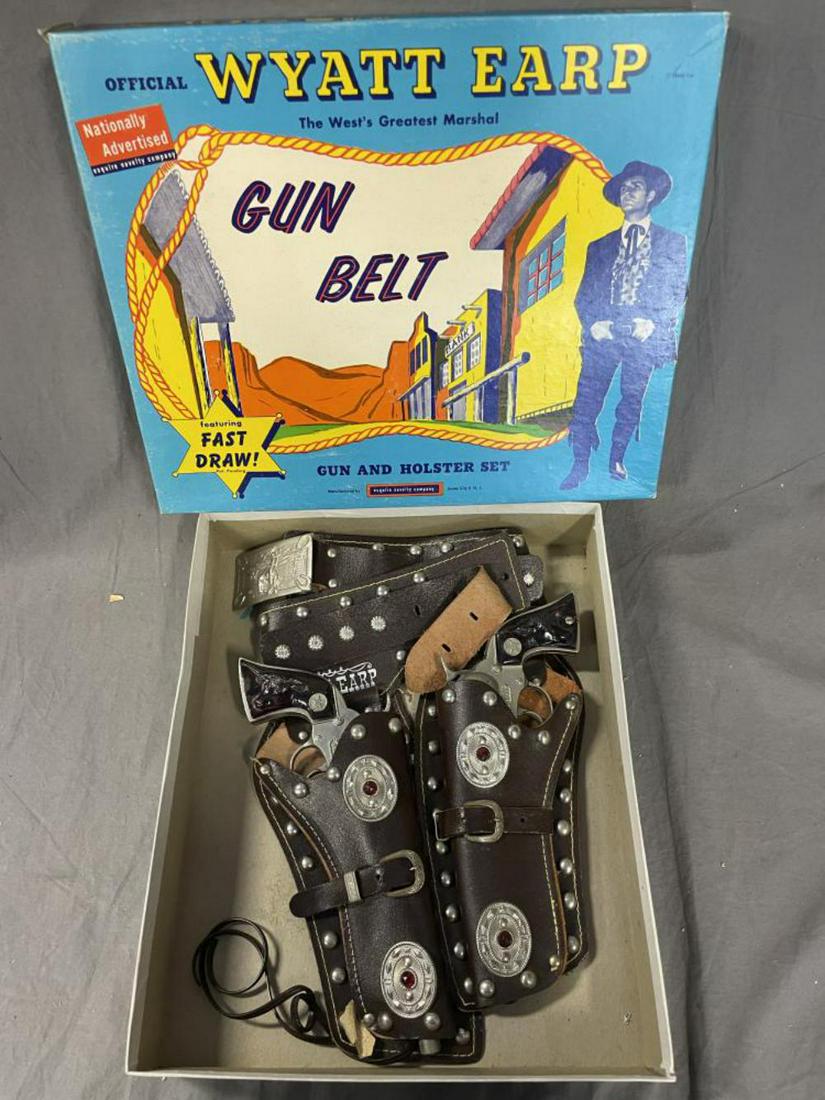 Boxed Wyatt Erp Double Gun & Holster Set 2735: Includes a Leather double holster set with tin rhinstone style decoration and jeweled accents. Includes 5/6 plastic bullets in sleeve and has a pair of Hubley Wyatt Erp Cap pistols, both functional. S