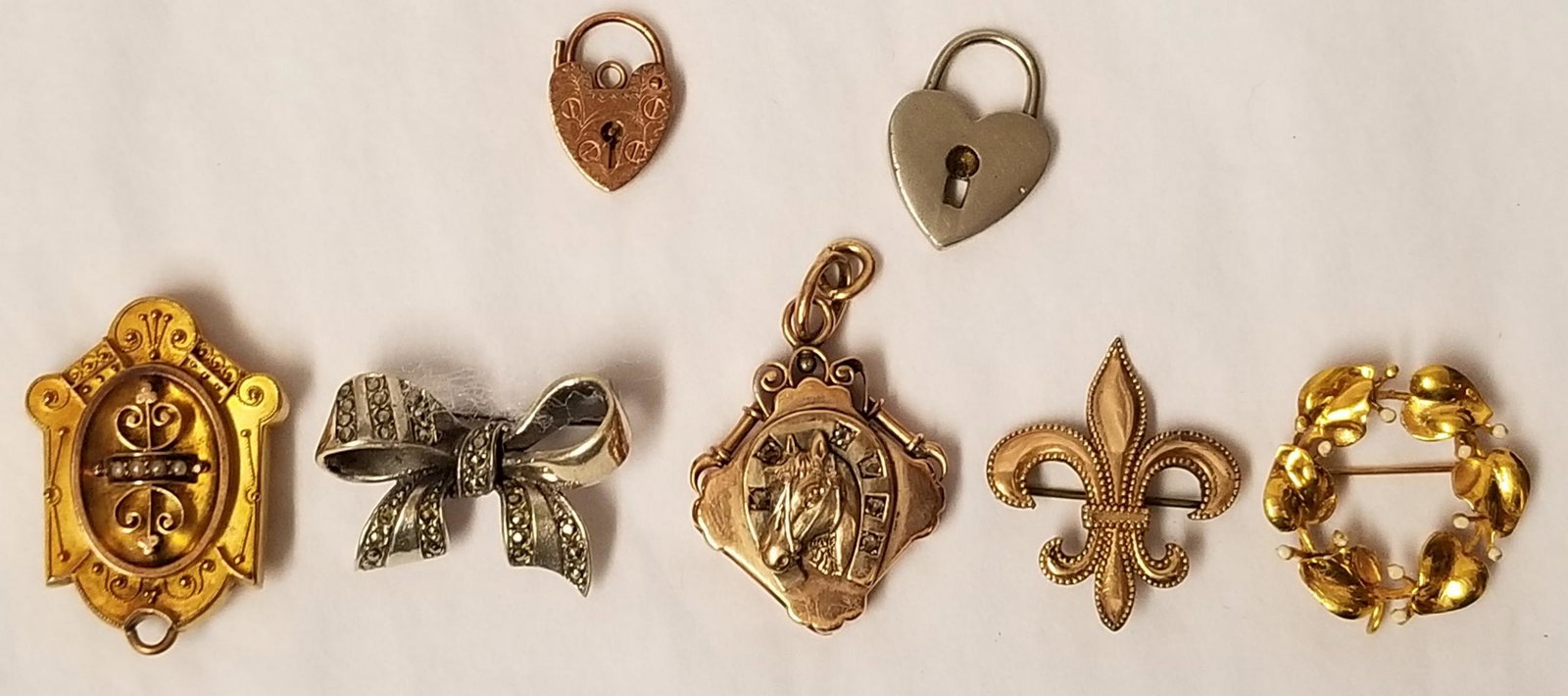 Lockets and Pins Lot of 7: Group of seven lockets and pins. 14K gold, gold filled, and silver