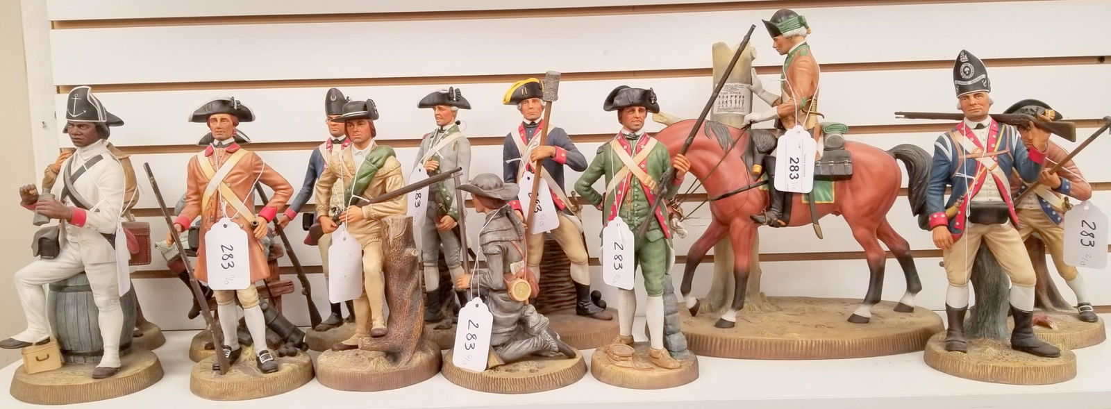 Royal Doulton, Soldiers of the Revolution, 13 Pcs: Lot consists of a 13 piece set, Royal Doulton, bisque porcelain "Williamsburg, Soldiers of the Revolution" figures. Includes soldiers representing the original 13 colonies including: North Carolina, P