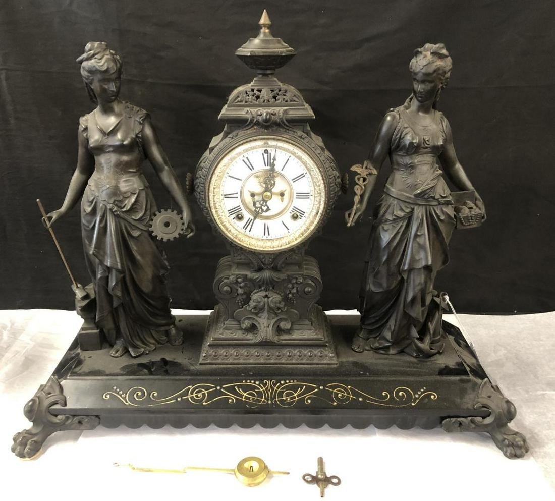 Ansonia Arts & Commerce Double Figure Clock: White metal, Ansonia "Art & Commerce" Double Figure Clock. Overall approx. 25-1/2" x 20-1/2" high x 9" deep. Dial appears to be porcelain. Claw feet at the front corners. Includes pendulum and key. Un