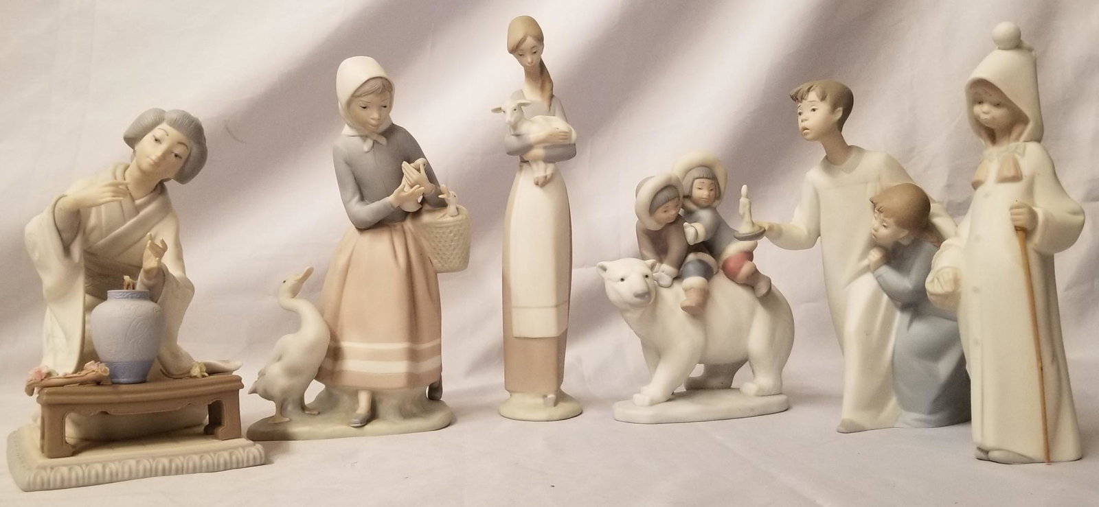 6 Piece Lladro Figurine Assortment Lot: Includes 7-1/2" Asian Geisha Flower Arranger (flower branch broken, but present), 9" Woman with Ducks and Basket, 8" Boy and Girl with Candle, 8-1/2" Girl with Basket and Walking Stick (stick broken),
