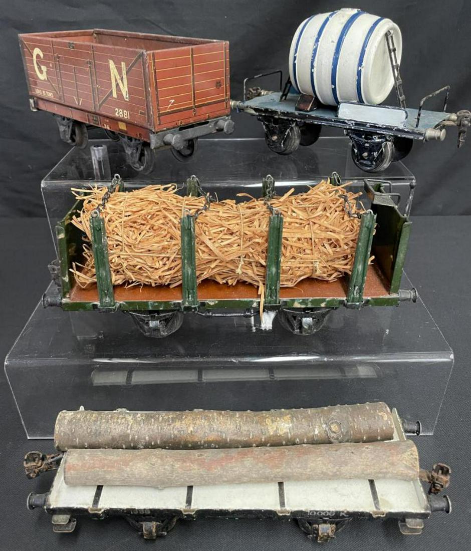 4 Clean Marklin 1 Gauge Freight Cars: Includes an 1833/1 hand-painted Hay Wagon; 1976/1 Wine Barrel car, missing top; 1988/1 Log Flat missing stakes; 2881/1 Litho GN 8-board open wagon, no couplers. All show light to moderate play wear.
