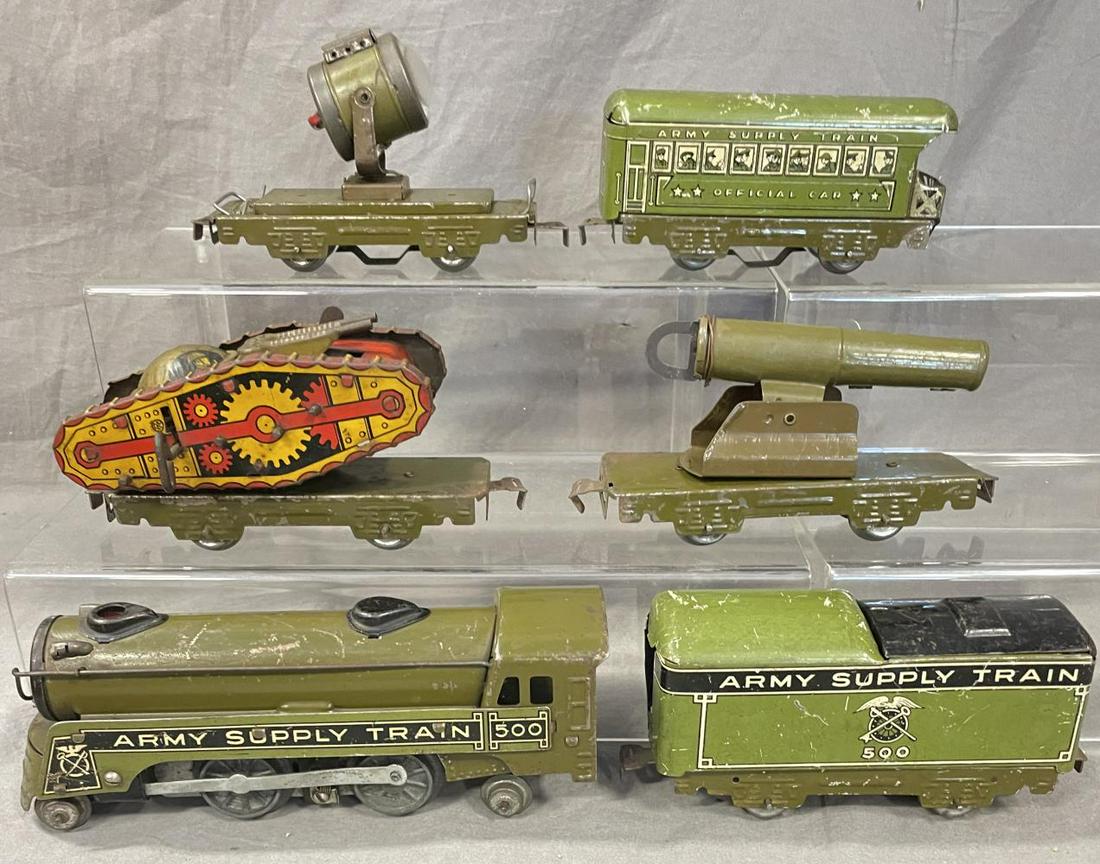 Clean 6pc Marx Military Train Set: Includes a deluxe 500 AST 2-4-2 Steam Loco; 500 AST tender; Field Gun flat; Flat with WWI tank, tank is dirty but functional; electric searchlight; Official Car with illuminated drum head, missing len