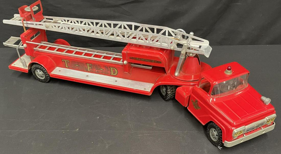 1959 Tonka Fire Ladder Truck: Painted pressed steel with hard rubber tires. It is clean and fairly shiny and retains one extension ladders. It shows light play wear.