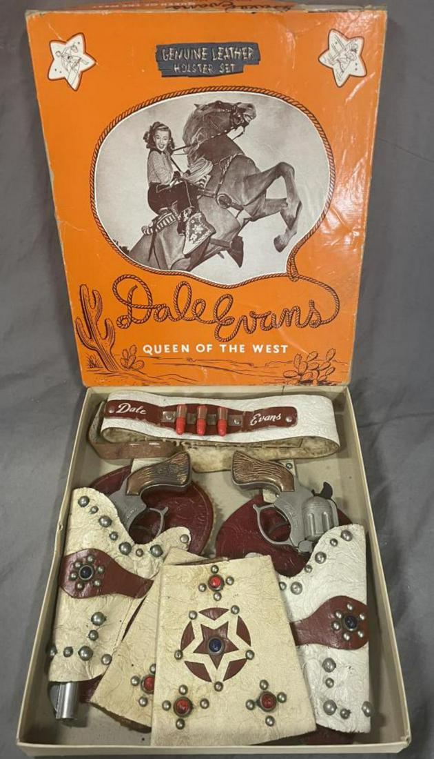 Boxed Dale Evans Double Cap Pistol Set: Fargo D4307. Includes a pair of die cast, possibly Hubley cap guns with metal copper plated grips, both function and show light signs of use; leather double holster set with 3 plastic bullets and matc