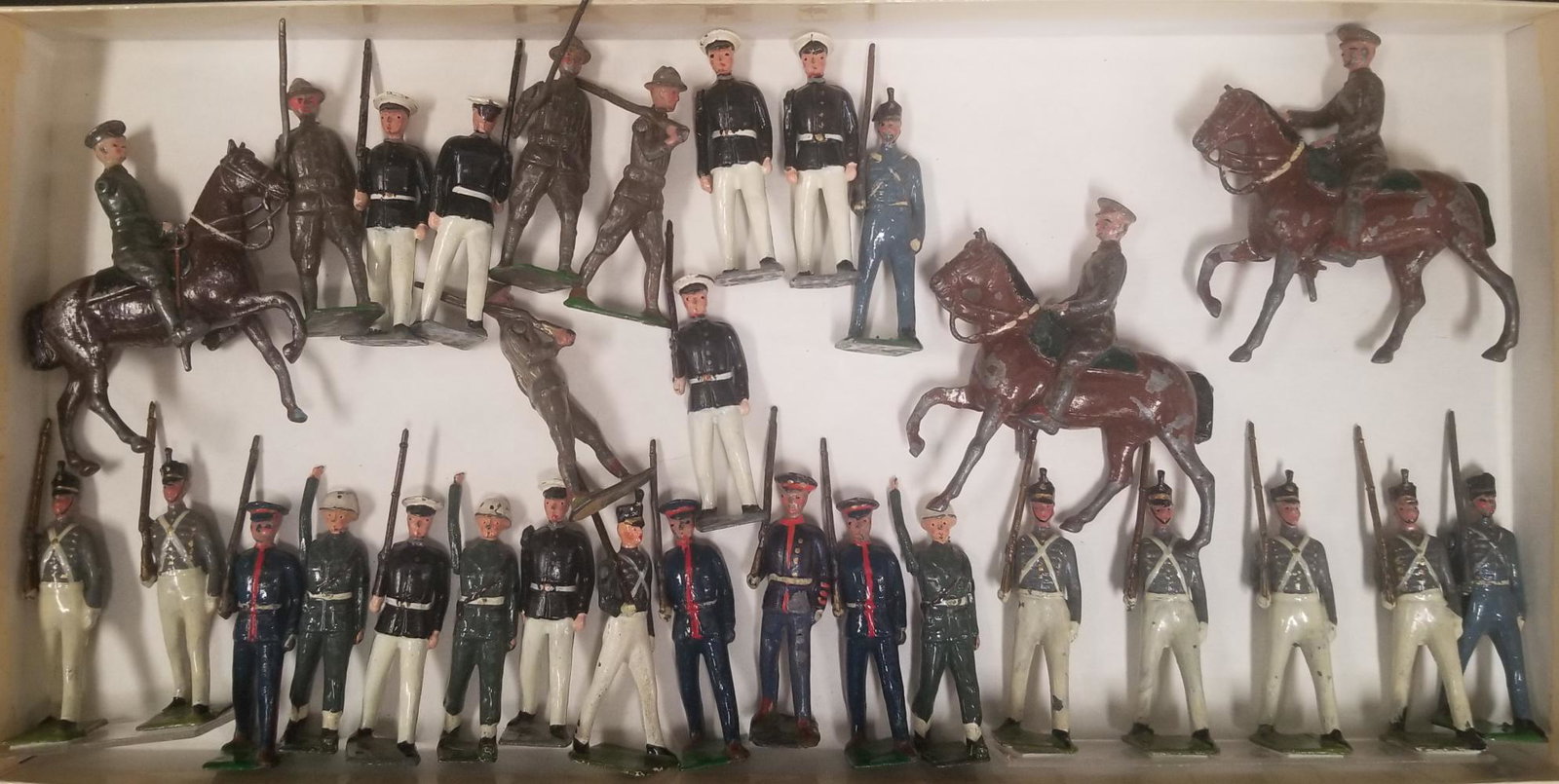 Britains Toy Soldier Lot, Mixed Pieces: Approx. 30 pieces. Includes Infantry and Cavalry pieces. All show wear with paint loss, scuffing, etc. Some missing limbs, 6 infantry figures are mounted to plexiglass.
