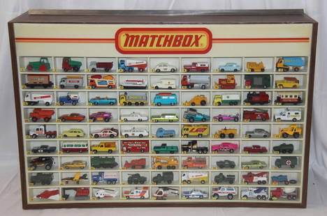 Matchbox Display Case with 81 Vehicles: Vintage 1980's Matchbox display case with 81 Matchbox vehicles. Cars present may not be in the correct order. Case measures approx. 32 1/4 by 21 1/2 by 9 1/4 inches. Back of case features sliding door