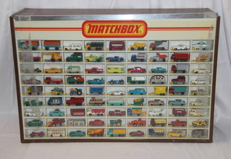 Matchbox Display Case with 81 Vehicles: Vintage 1980's Matchbox display case with 81 Matchbox vehicles. Cars present may not be in the correct order. Case measures approx. 32 1/4 by 21 1/2 by 9 1/4 inches. Back of case features sliding door