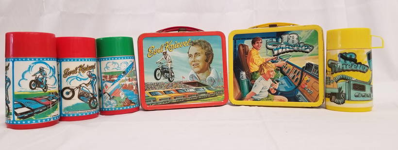 (2) Tin Litho Lunch Box Sets and 2 Extra Thermoses: 2 tin litho lunch boxes with thermoses including Evel Knievel and 18 Wheeler, with 2 additional Evel Knievel thermoses. Minor wear and paint loss.