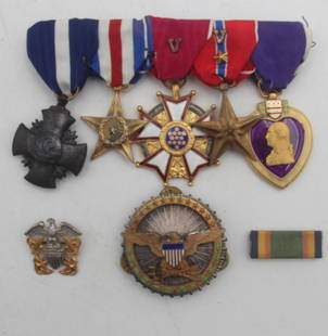 WWII Navy Medal Group: WWII Navy medal group including Purple Heart, Bronze Star, Legion of Merit, Silver Star and Navy Cross on bar (none engraved), Sterling Department of Defense Eagle badge and sterling and gold filled n