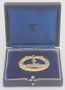 WWII German U Boat War Badge in Box: WWII German U Boat War Badge (U-Boot-Kriegsabzeichen) in presentation box. Late war gold washed version with vertical pin, marked F.O. (Friedrich Orth) on reverse. Gold wash has worn off most of the r