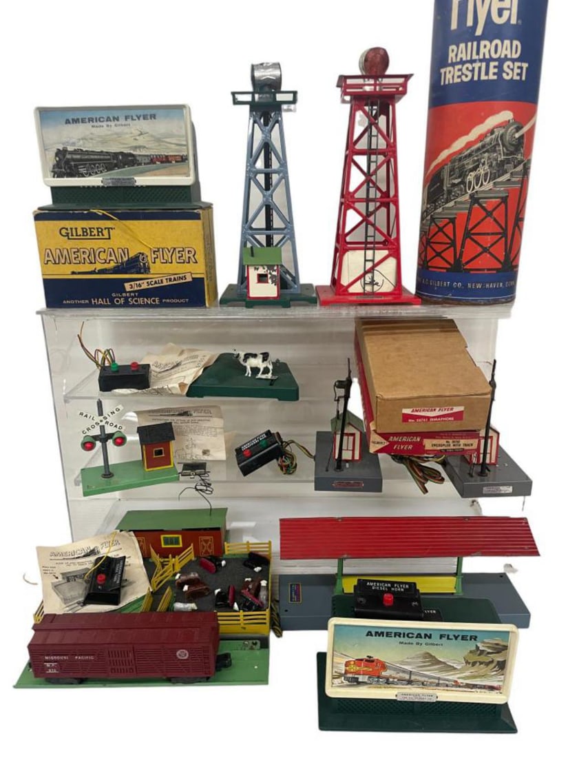 13 Vintage American Flyer Accessories: S Gauge. Includes 771K Cattale Platform with 976, complete with instructions; 758 & 758A Sam The Semaphore Man with buttons; 759 Bell Danger with trip ; 23791 Cow on Tack with button & instructions; 7