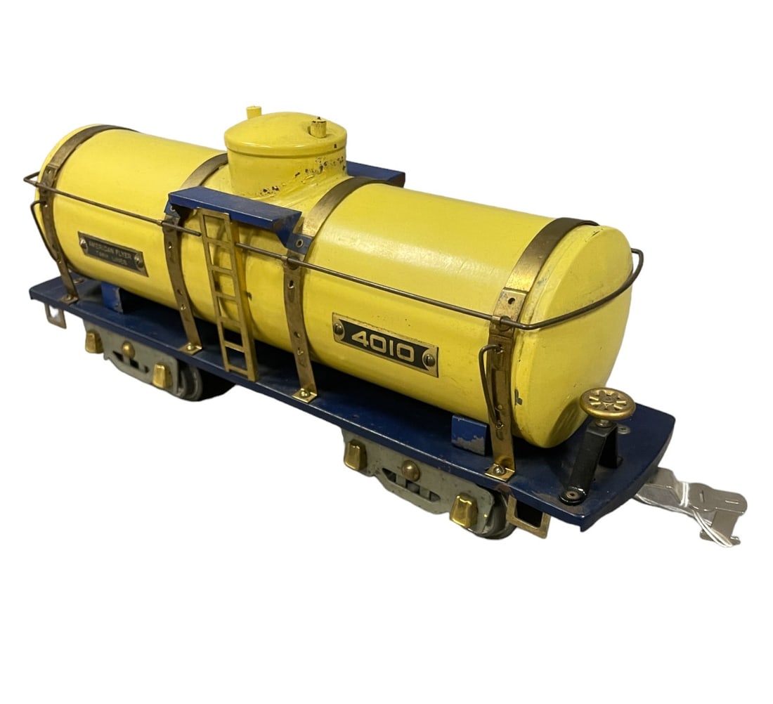 Nice American Flyer 4010 Tank Car: Standard Gauge. Fairly clean with tarnished brass trim. There is some flaking around the dome sides, otherwise it shows light play wear.