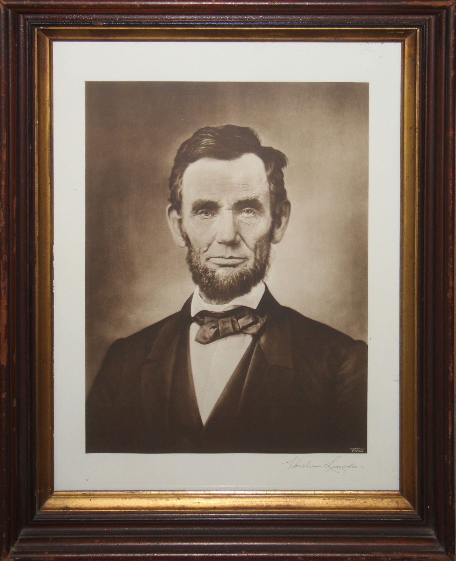 Photogravure by Moses Rice of Abraham Lincoln: 20th century photogravure of Abraham Lincoln in his iconic portrait pose. This photogravure by Moses Rice is known as the "Gettysburg Lincoln." The print was derived by Alexander Gardner. Sight seen a