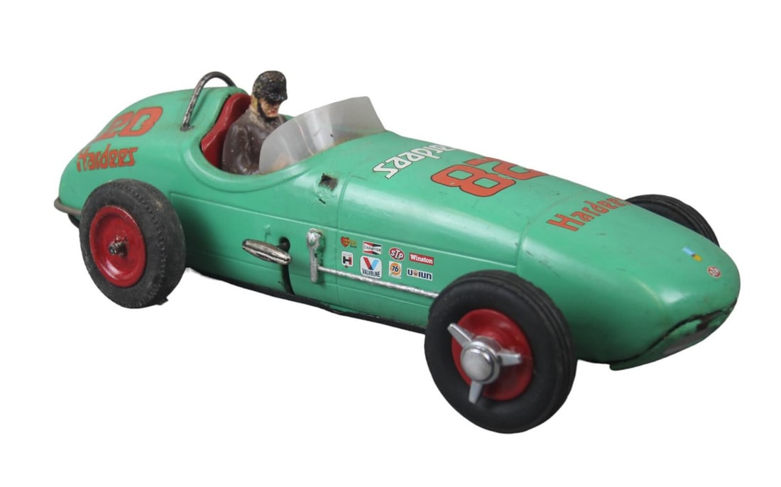 Redone Cragstan Series 4247 Indianapolis 500 Racer: Litho tin friction with automatic jack, 15 inches long. has been repainted and customized with composition interior with driver, missing 3 spun hubs.