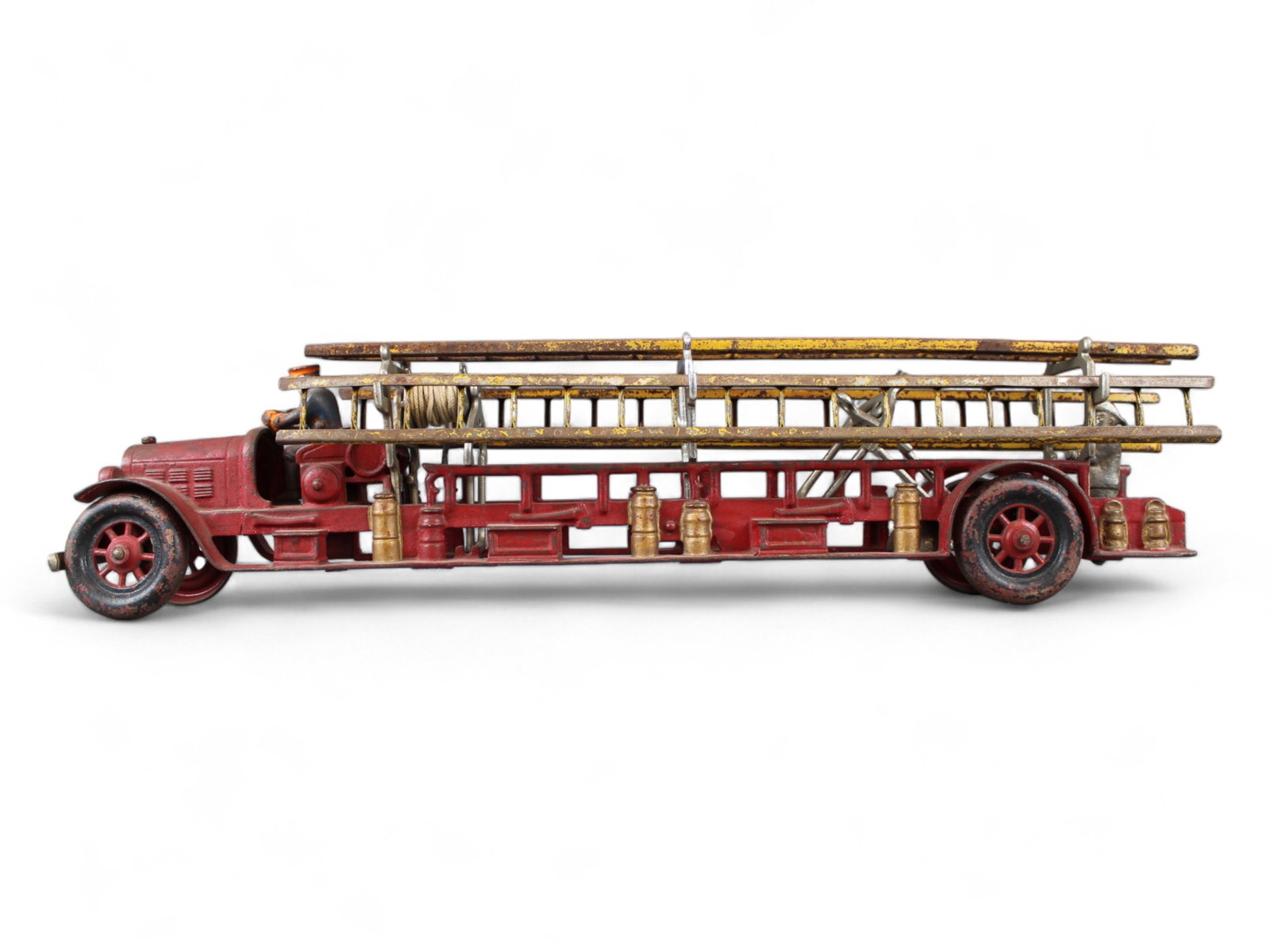 Kenton Cast Iron Fire Ladder Truck: Kenton cast iron fire ladder truck, approx. 22 1/4'' long. With original cast driver and pressed tin ladders.