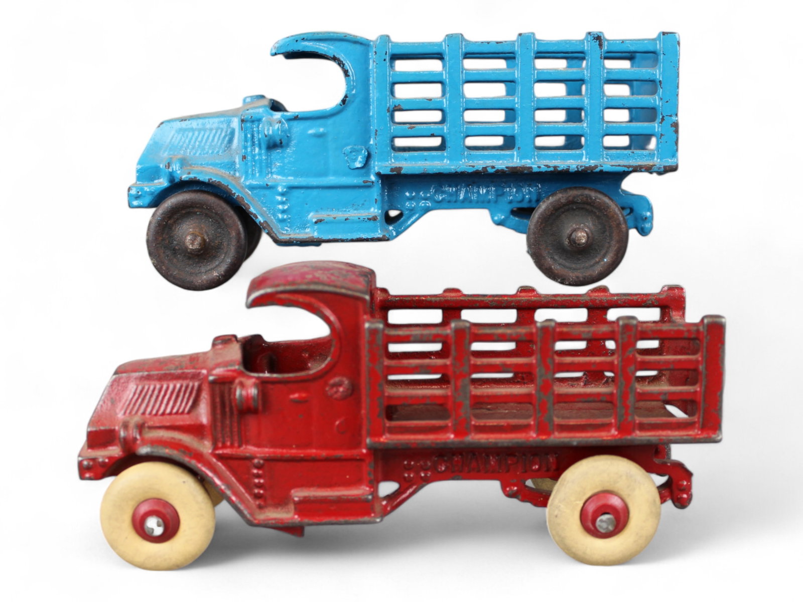 (2) Champion Cast Iron Stake Trucks: 2 Champion Cast Iron Stake Trucks, each approx. 7 1/2'' long. Some paint loss.