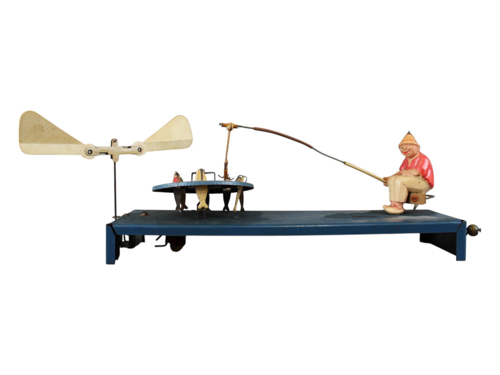 Very Interesting Mechanical Fisherman: Metal base with celluloid fisherman. 13" long metal base with spinning wheel full of fish and Celluloid "weather vane" type apparatus. Works when manually rotated. Frankly, not sure how it works but i