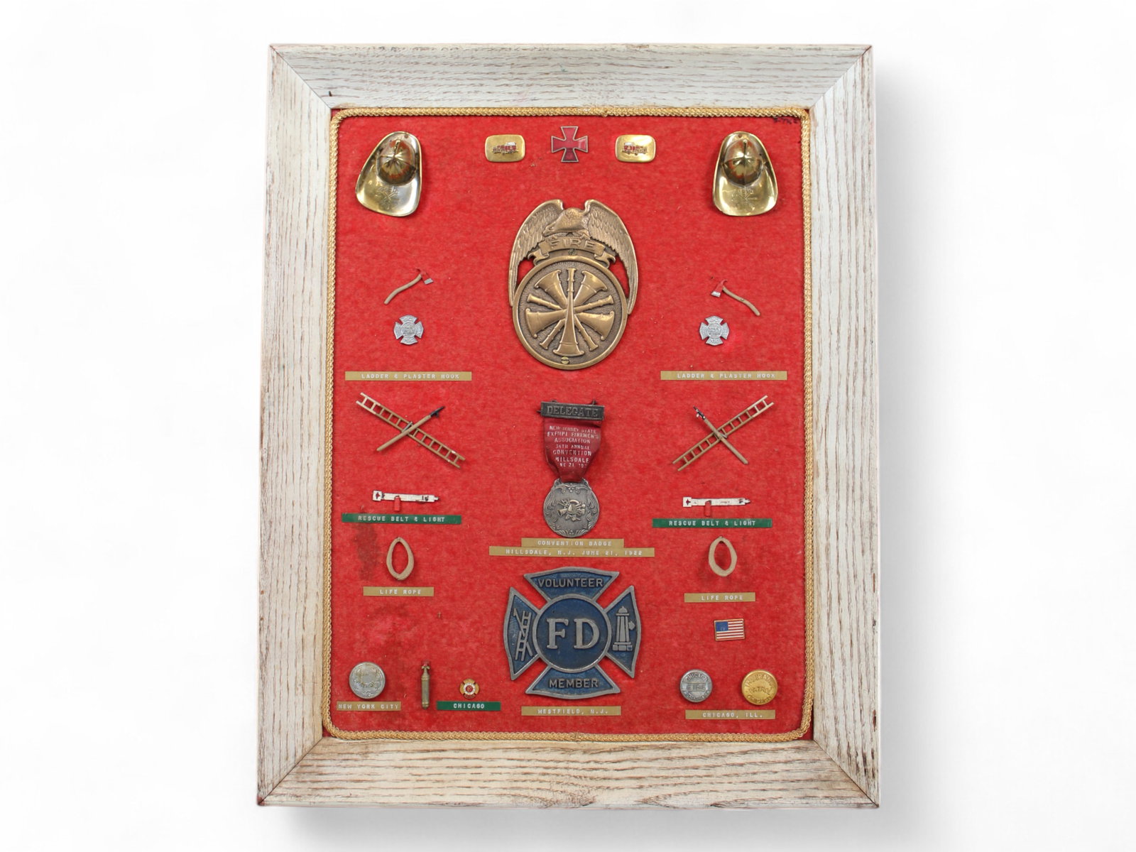Firefighters Display Board: Includes Convention Badge from 36th Annual Convention Hillsdale, NJ June 21, 1922, Buttons from NYC Fire Patrol, Chicago Fire Department, and Chicago Insurance Patrol, Volunteer Member Medallion, and