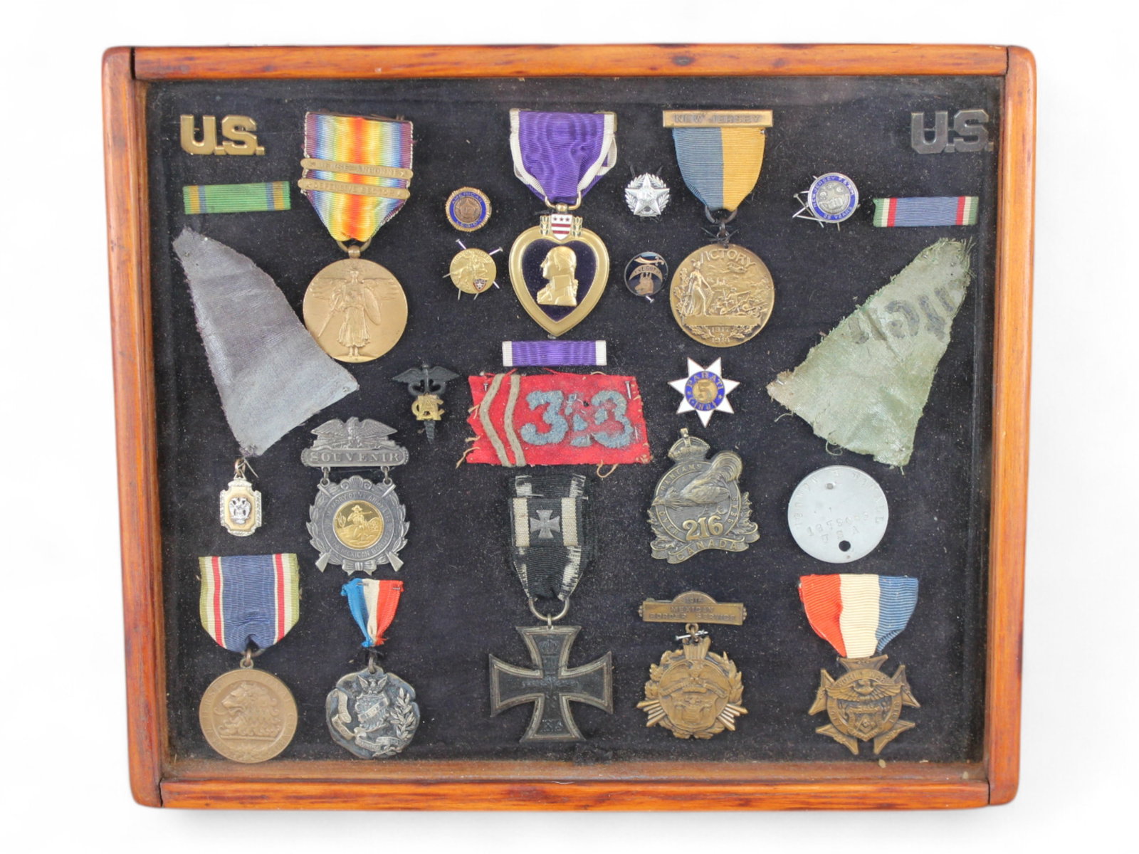 WWI & Mexican Border Shadowbox Display: Shadowbox display of military medals, patches, and pins including Mexican Border Service and World War I. Interesting group. Dog tag and Purple Heart are for Robert H. Donall; it is unclear whether th