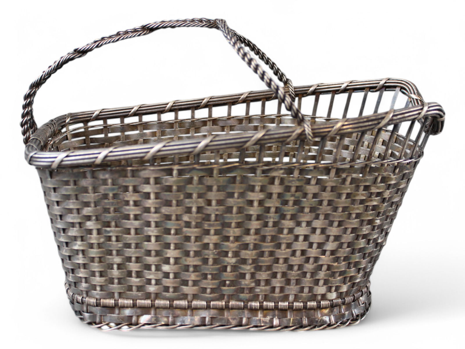 French Silver Plate Wine Bottle Basket, Christofle: French silverplate, possibly Christofle, marked "Made in France" with hallmarks on bottom. Twisted wire handle with woven basket design. Approx. 9-1/4" x 4-3/4" x 6-1/2".