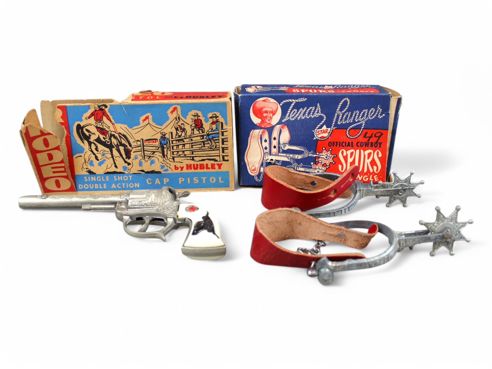 Western Lot of (2): Lot includes Hubley Rodeo Cap Gun in Partial Box together with Leslie Henry Texas Ranger spur Set Boxed.