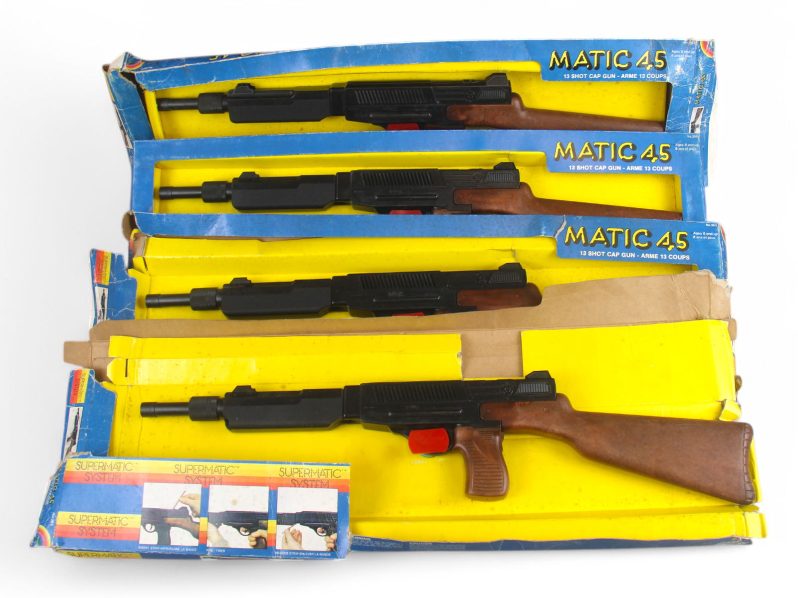 Lot of 4 Rifle Matic 45 Cap Guns: Edison Giocattoli. Each cap rifle is still attached to cardboard box, however boxes to all are rough with tears, creases, crushing, etc. Requires strip caps, not included.