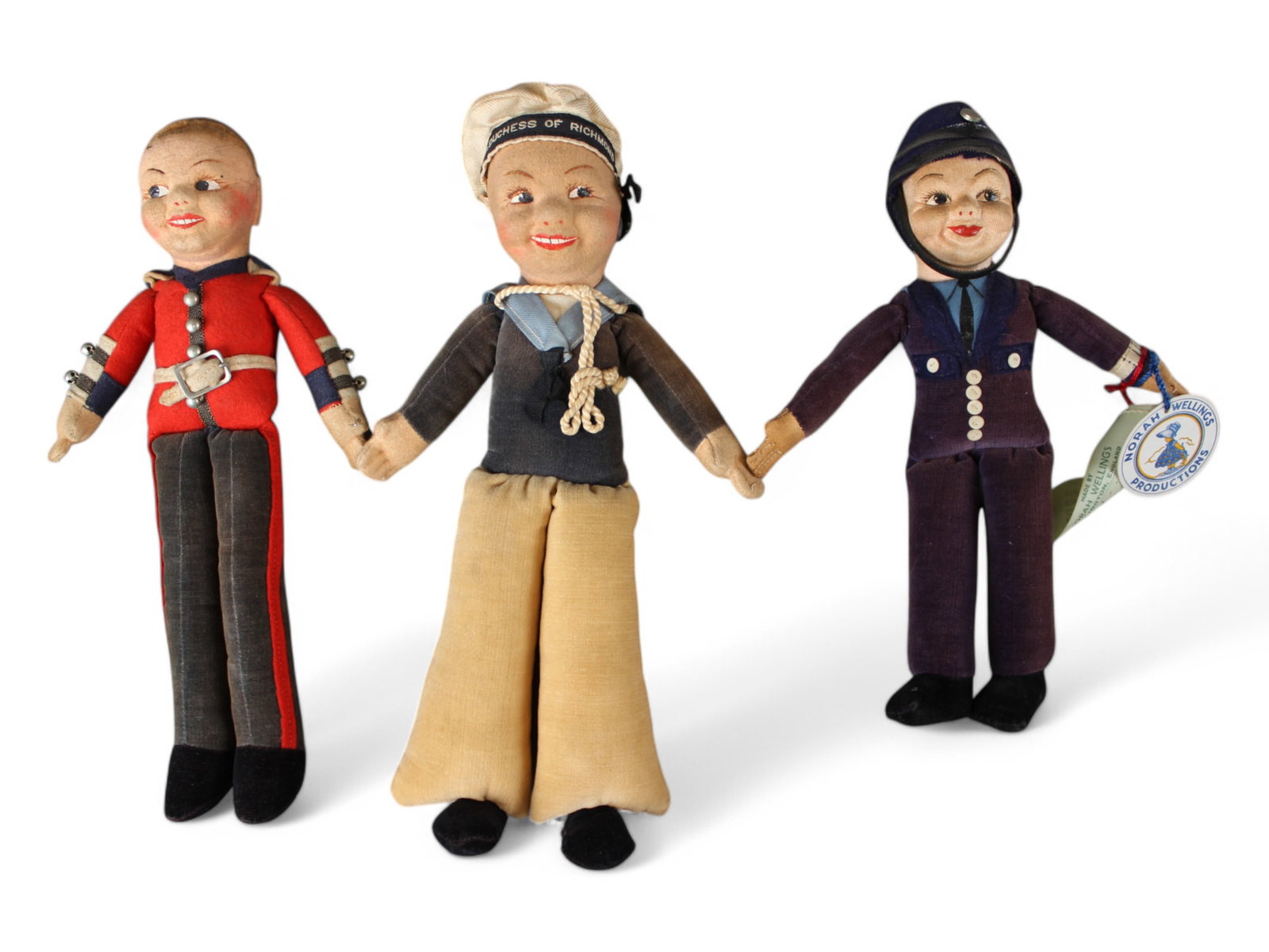 Norah Wellings Lot of (3): Includes 11" Sailor, Mountie missing his hat and Police Man "Bobbie", all in need of a good cleanup after being on a shelf for many years untouched.This lot is being offered on behalf of the New York 