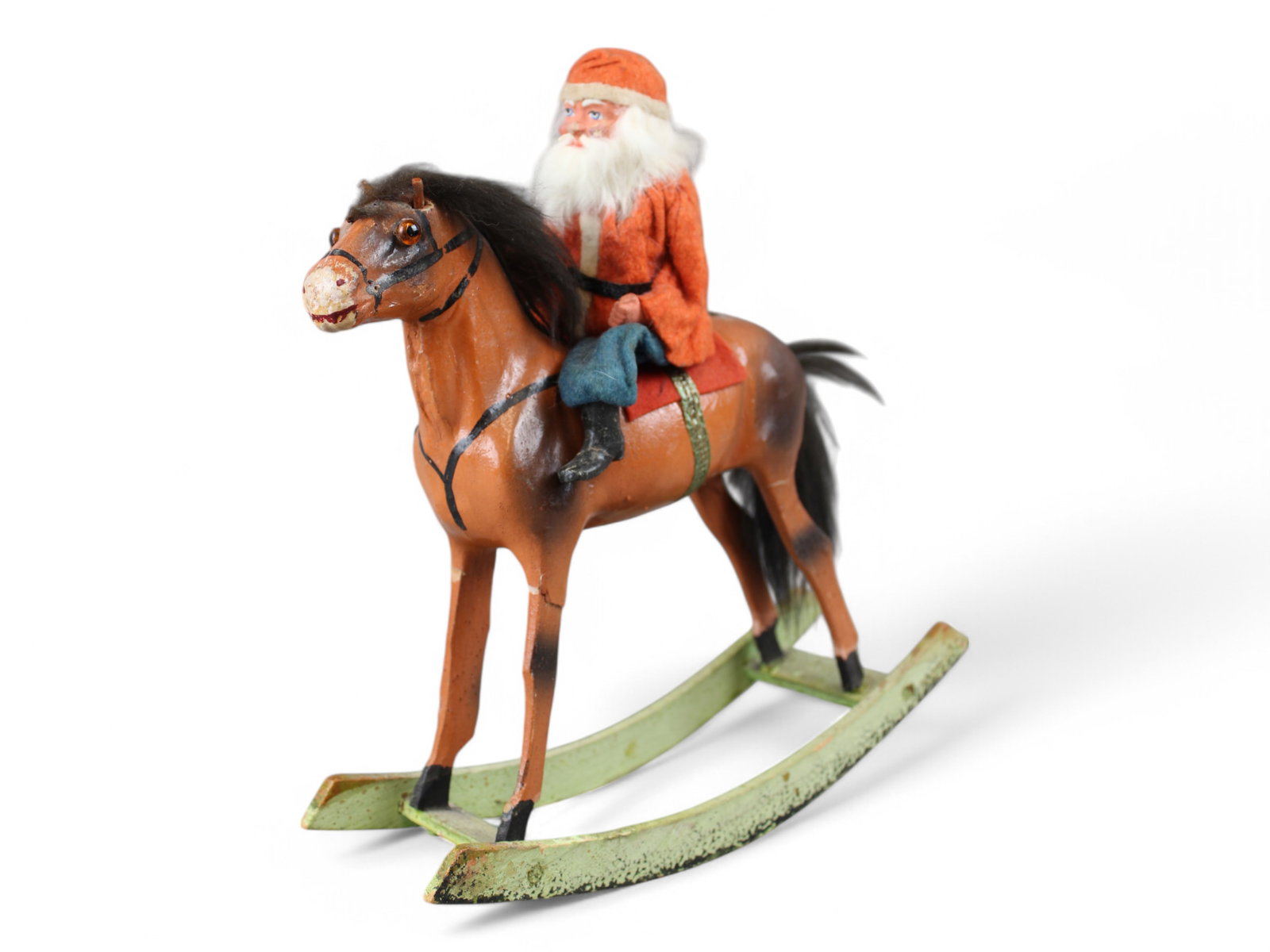 Santa on Rocking Horse: Vintage Composition Santa on Composition and Wood Rocking Horse. 12" tall and 10 1/2" long. Santa marked Germany, Horse has glass eyes, wood stake in ear holes, needs cloth or leather ears.