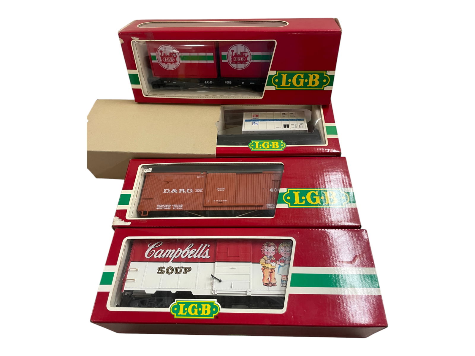 4 LGB Freight Cars: 1/G Gauge. Includes 4069 Container; 41911 Campbells BC; 4067 Boxcar; 4003 Container. All show light use with nice boxes.