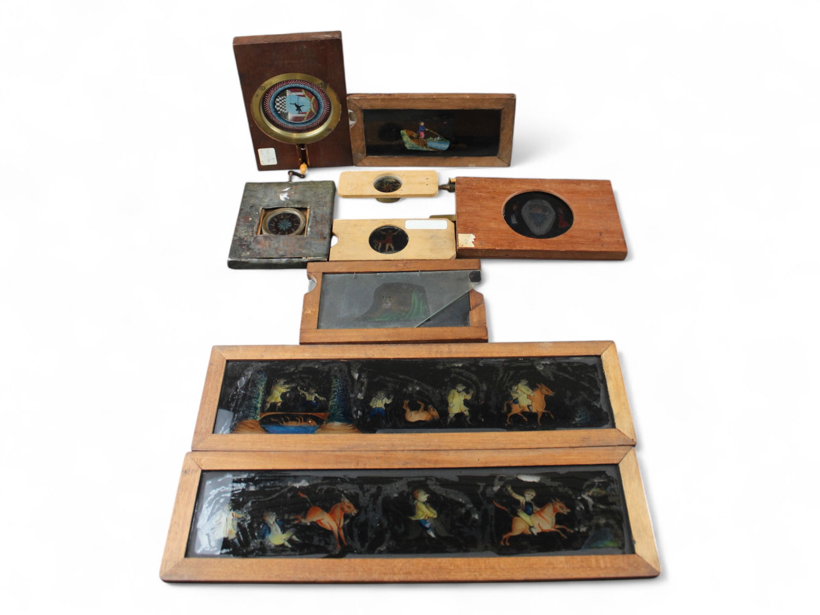 Vintage Magic Lantern Mechanical Glass Slides: Lot of assorted mechanical glass slides including kaleidoscopes and others. Each shows wear, some light chips to the glass. Some not working. See images.