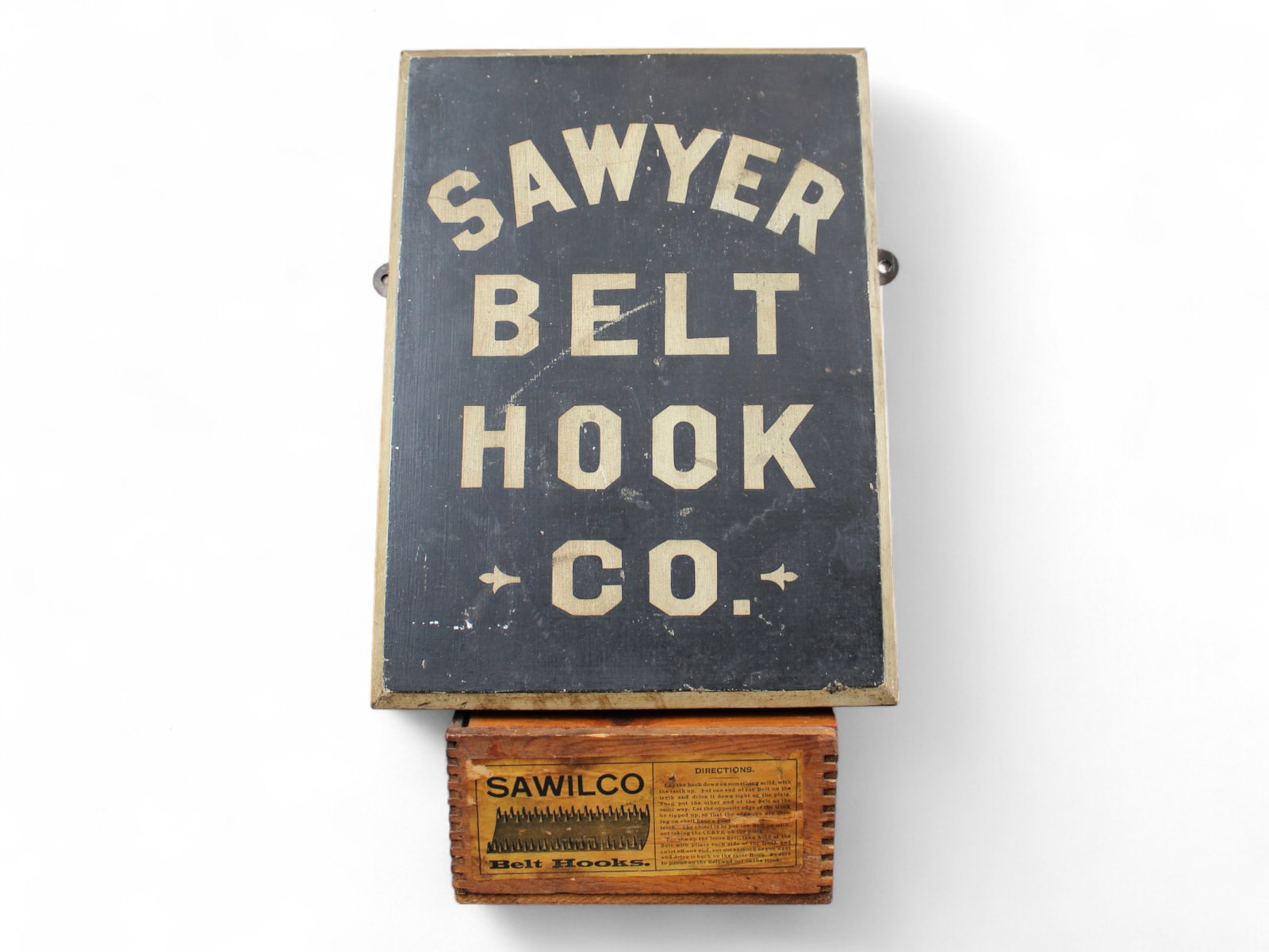 2 Piece Advertising Lot, Sawyer Belt Hook Co 1890s: Includes 8-1/2" x 12" wooden sign, along with wooden box (6-1/2" x 3-1/2" x 3-1/2"). Both show some wear.